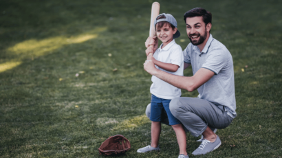 dad teaching son how to play baseball
