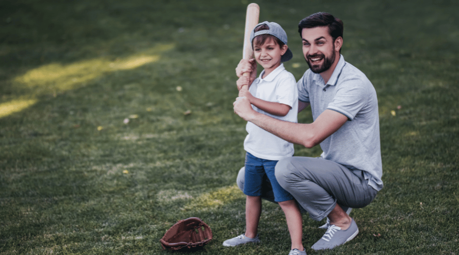 dad teaching son how to play baseball
